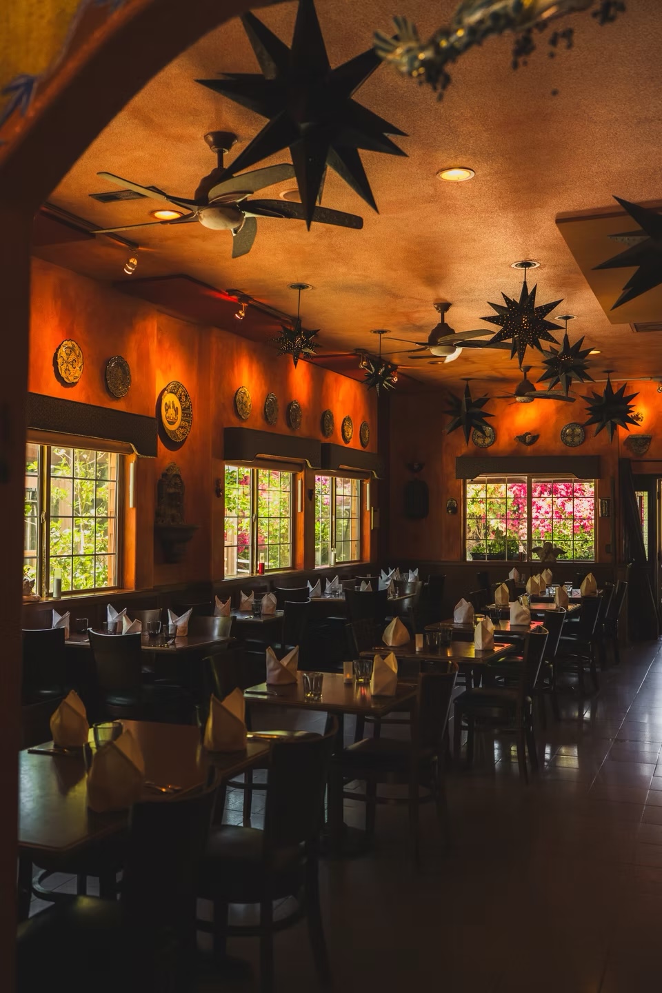 Warmly lit dining room with star lanterns at Vive Sol